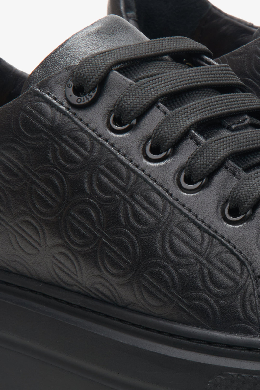 Women's black leather sneakers by Estro - close-up on the details.