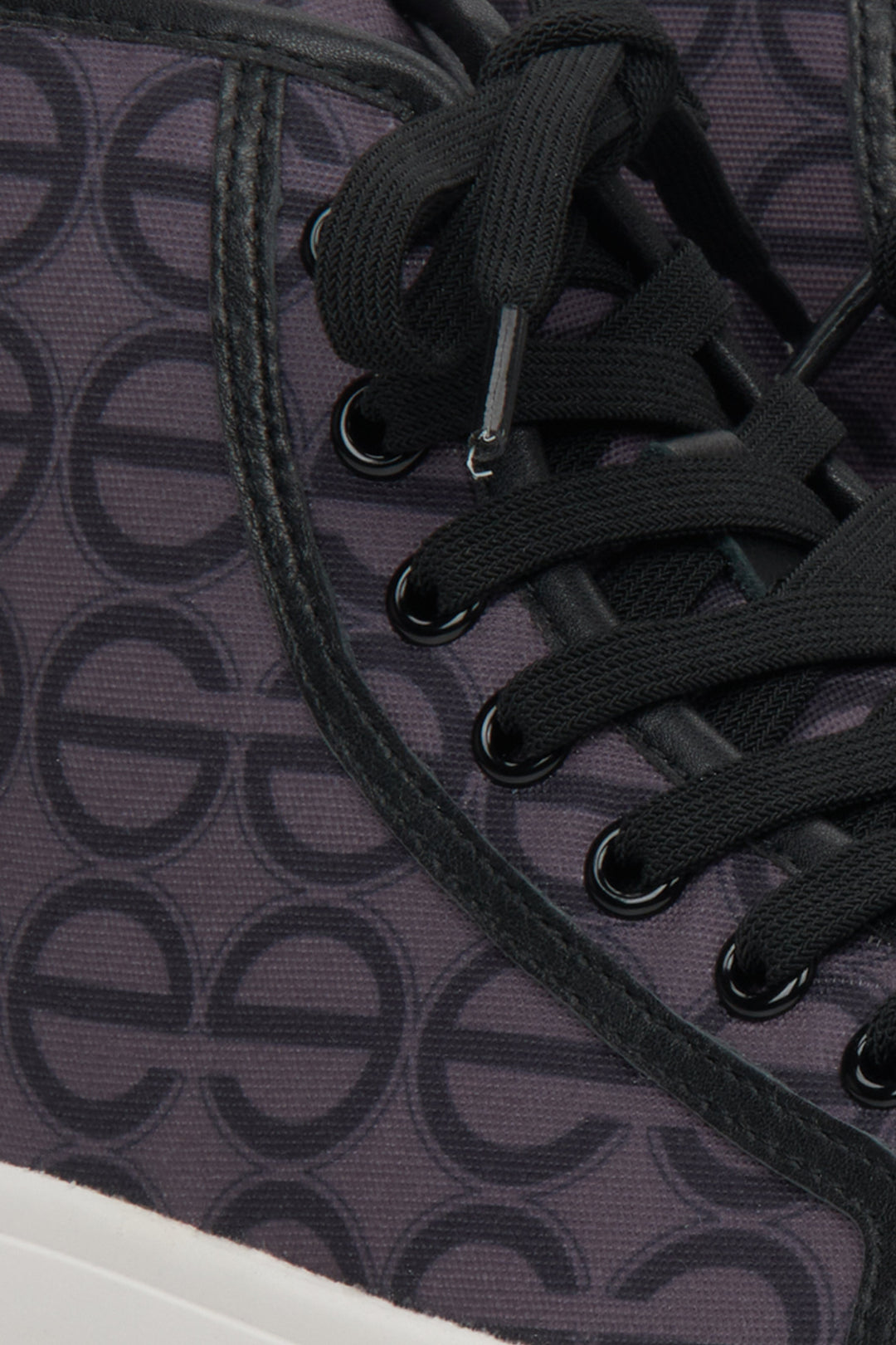 Women's high top sneakers in purple and black - close-up on details.
