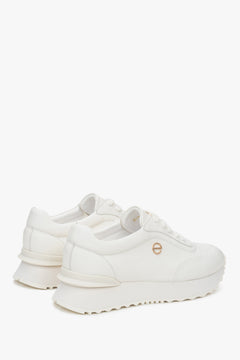 White women's sneakers made of genuine leather with a soft sole.