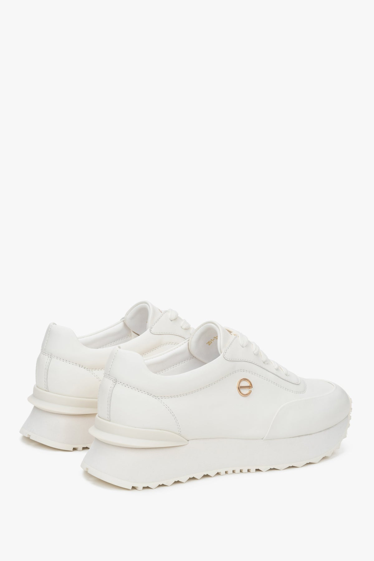 White women's sneakers made of genuine leather with a soft sole.