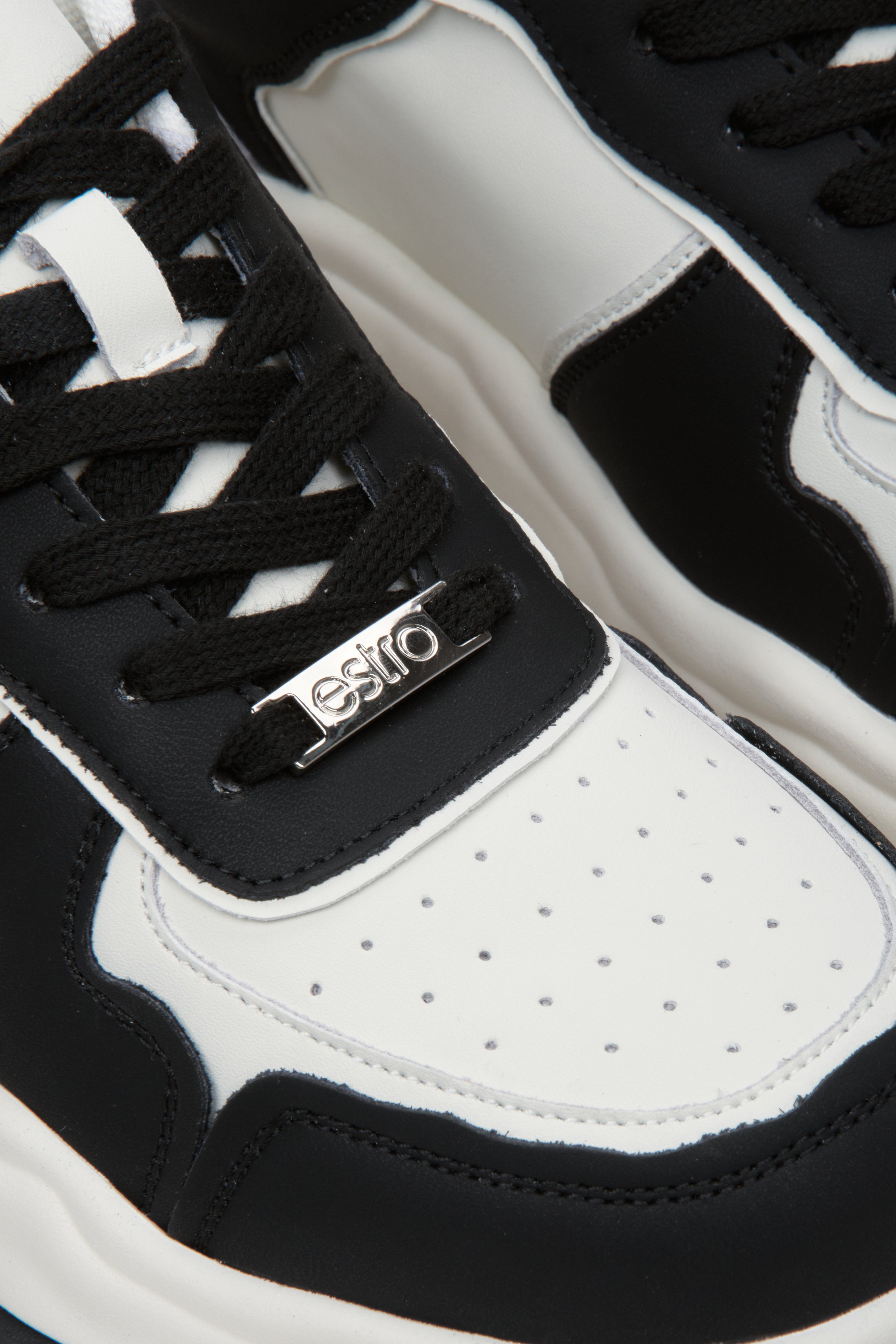 Women's leather sneakers in black and white by Estro - close-up on the details.