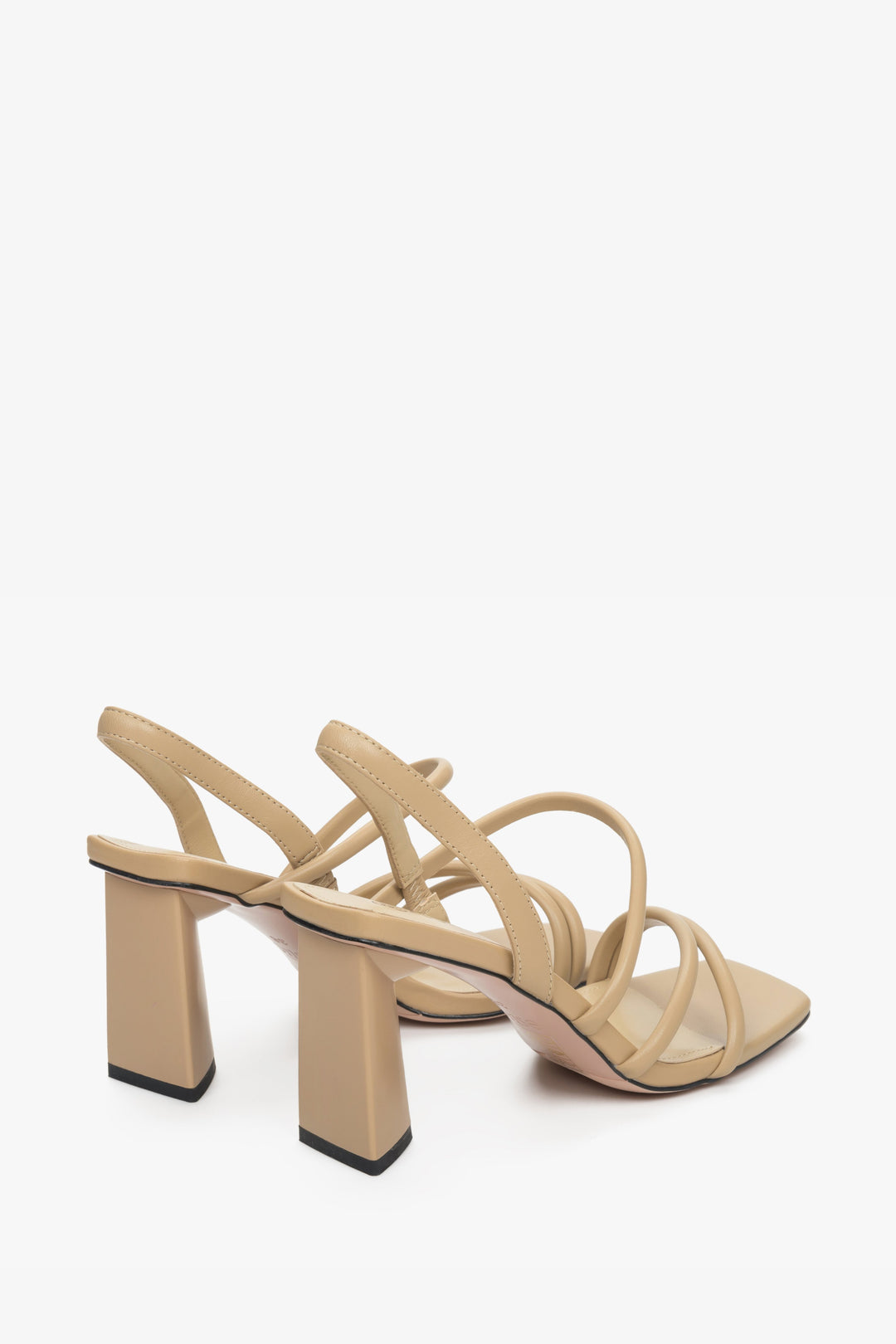 Sand beige strappy women's leather sandals on a block heel - a close-up on the bottom line.
