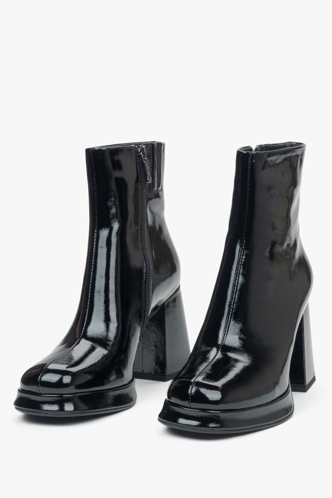 Black patent leather women's ankle boots on a platform with a stable heel by Estro - back of the model.