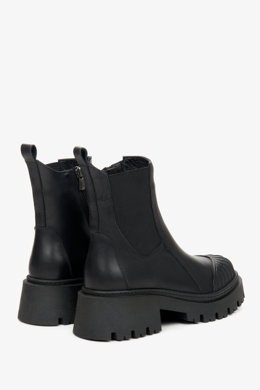 Black women's leather ankle boots by Estro - close-up on the side profile and heel of the model.