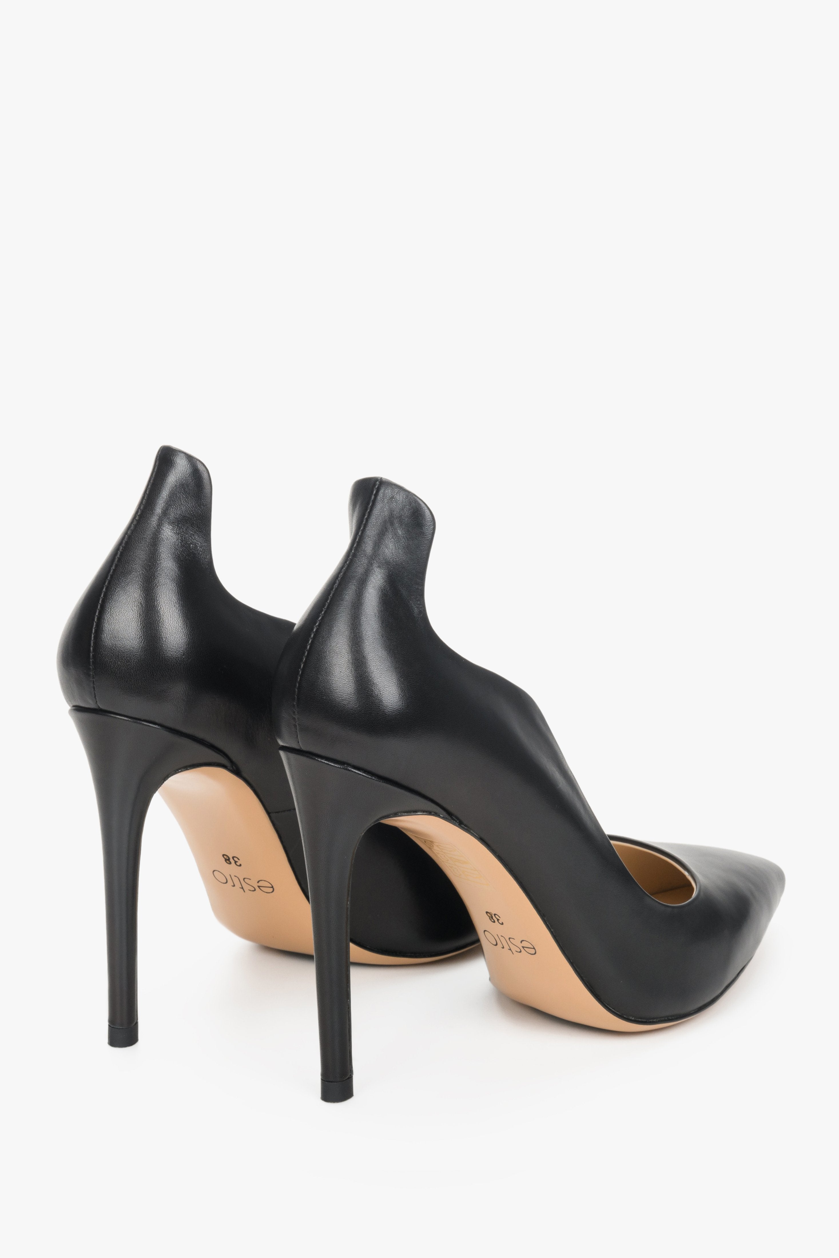 Women's black high heels made of genuine leather by Estro with a wavy edge - close-up on the heel and the shoe's back.