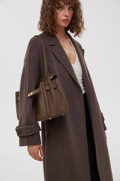 Women's long classic saddle brown coat with a belt by Estro.