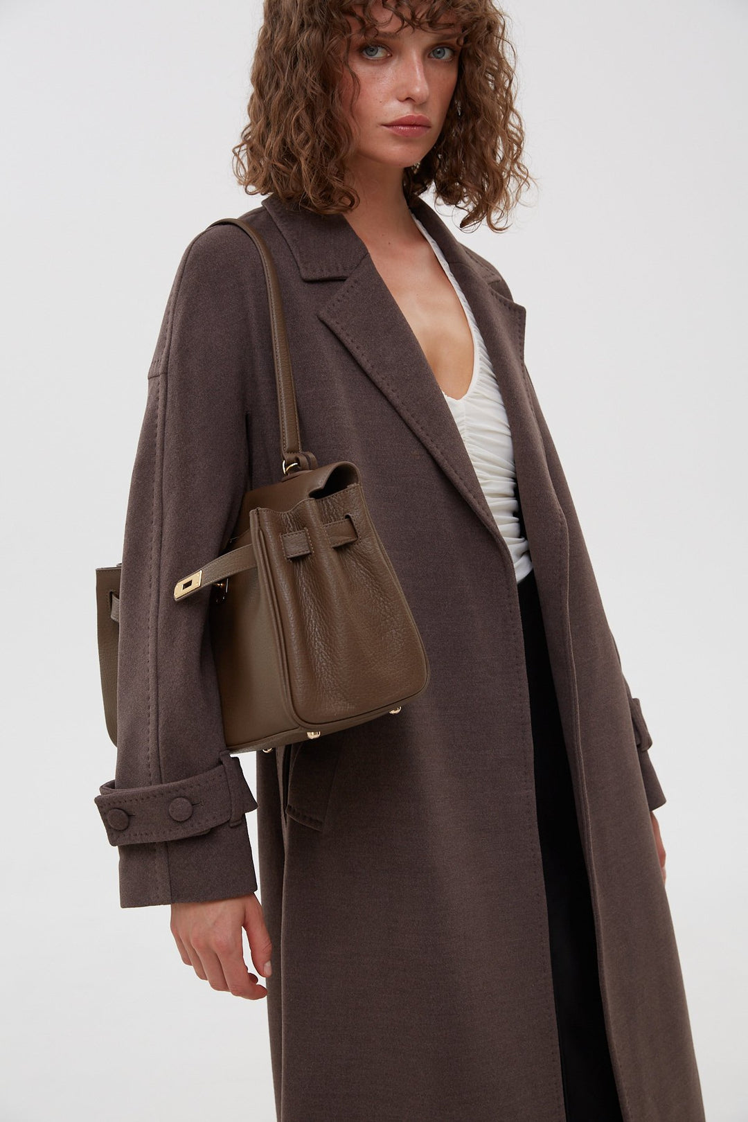 Women's long classic saddle brown coat with a belt by Estro.