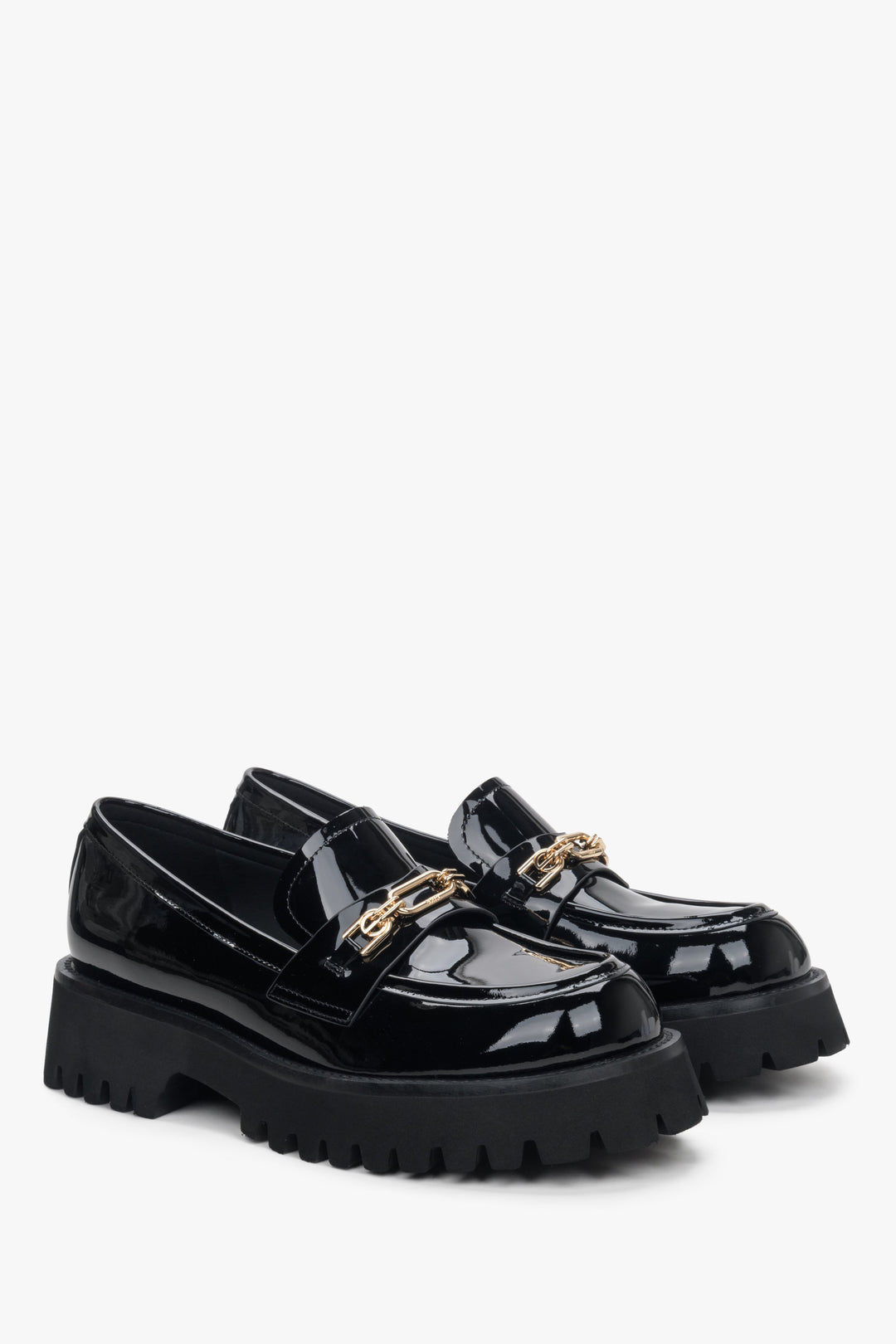 Women's black moccasins with gold buckle made of patent leather by Estro.