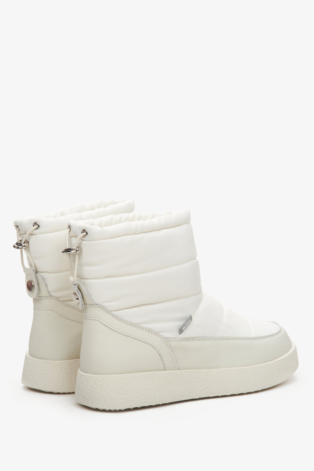 Women's snow boots in light beige made of genuine leather and fur - close-up on the side line and heel.