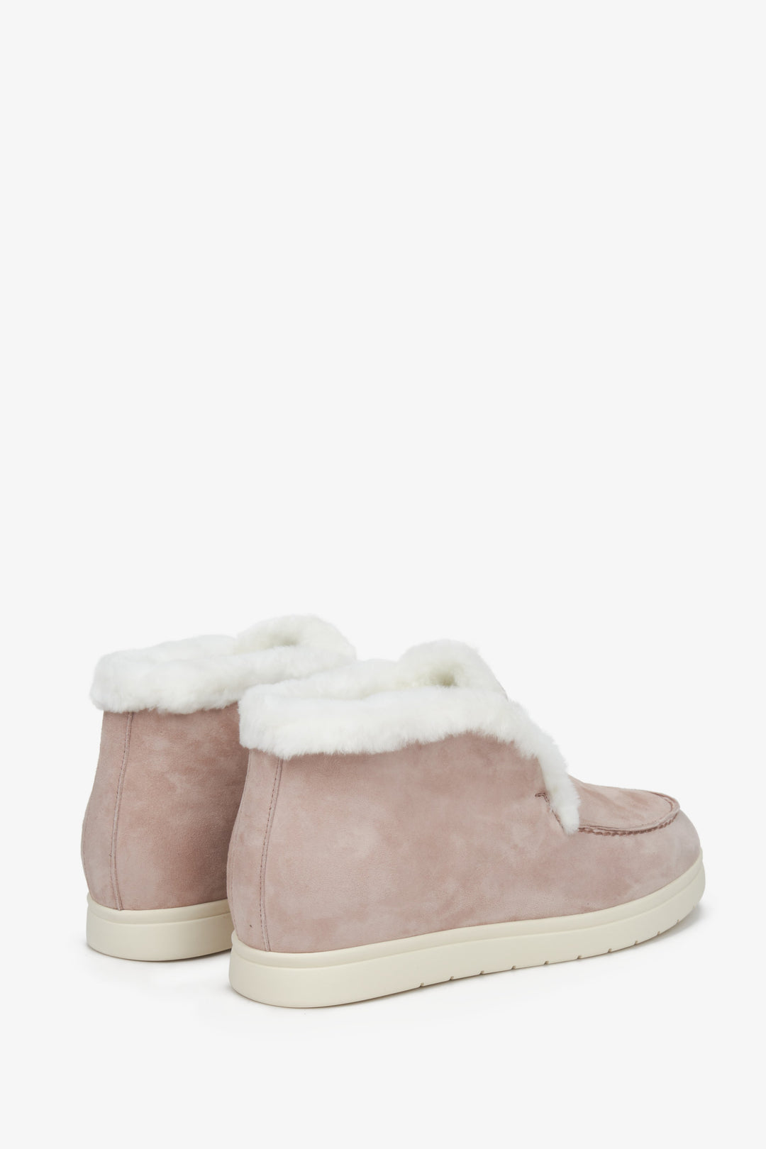 Elevated women's winter moccasins in pink suede with natural fur - close-up on the back of the shoe.