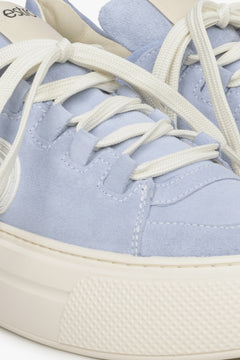 Women's blue sneakers made of genuine leather - close-up on details.