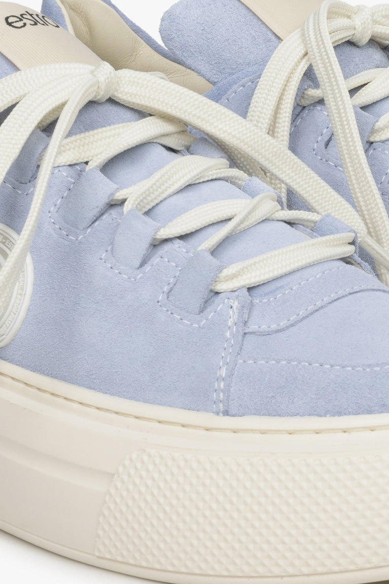 Women's blue sneakers made of genuine leather - close-up on details.