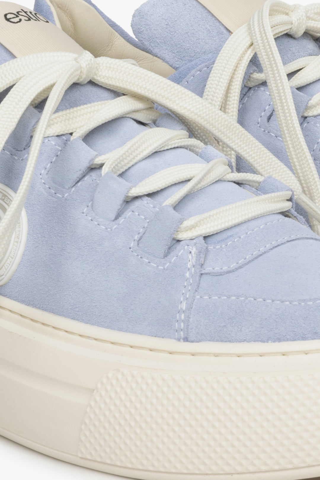 Women's blue sneakers made of genuine leather - close-up on details.