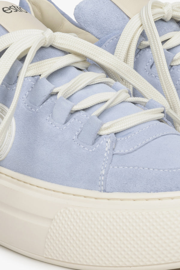 Women's blue sneakers made of genuine leather - close-up on details.