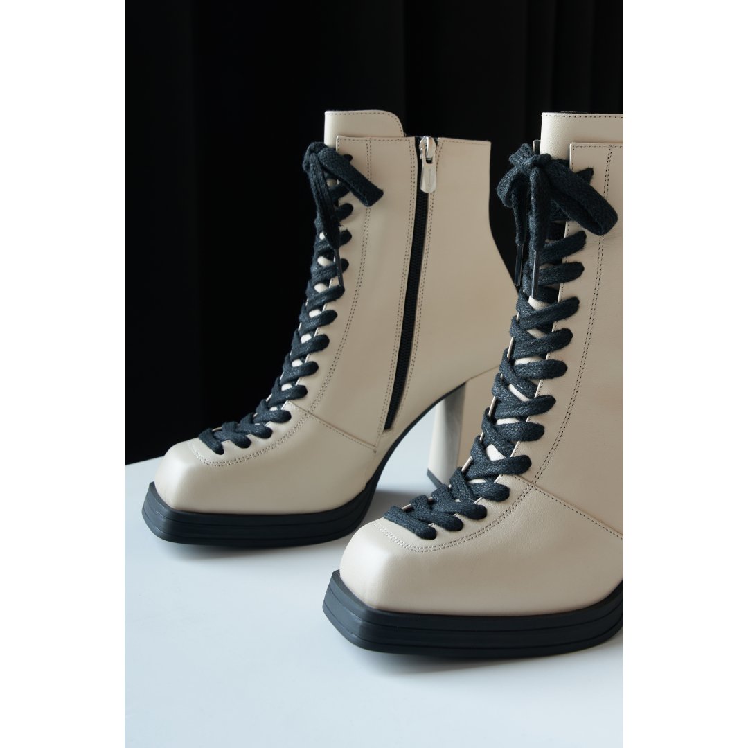 Women's beige ankle boots with a square toe and a heel.