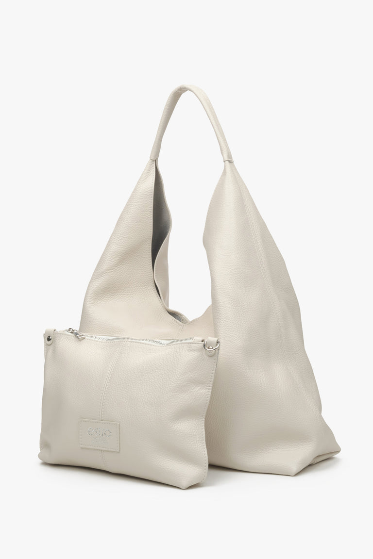 Women's cream beige hobo bag with zipped makeup bag.