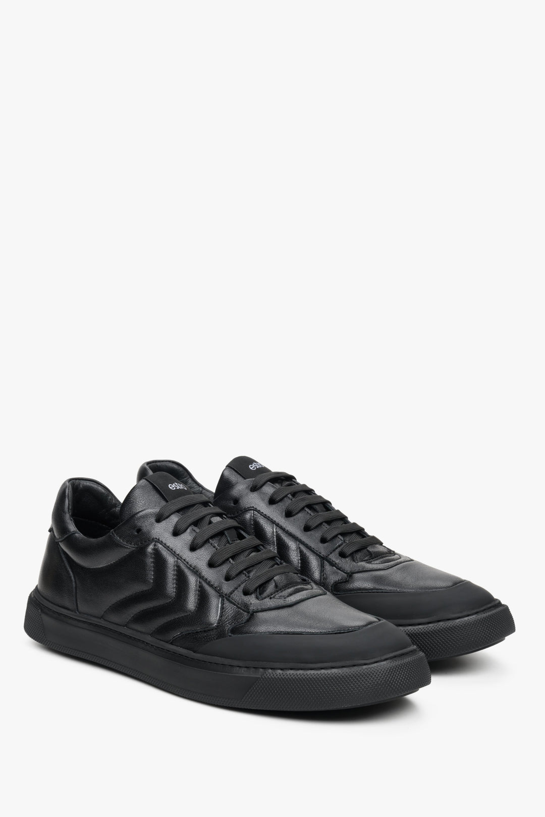 Low, lace-up men's sneakers made from genuine black leather by Estro - close-up of the front part of the shoe.