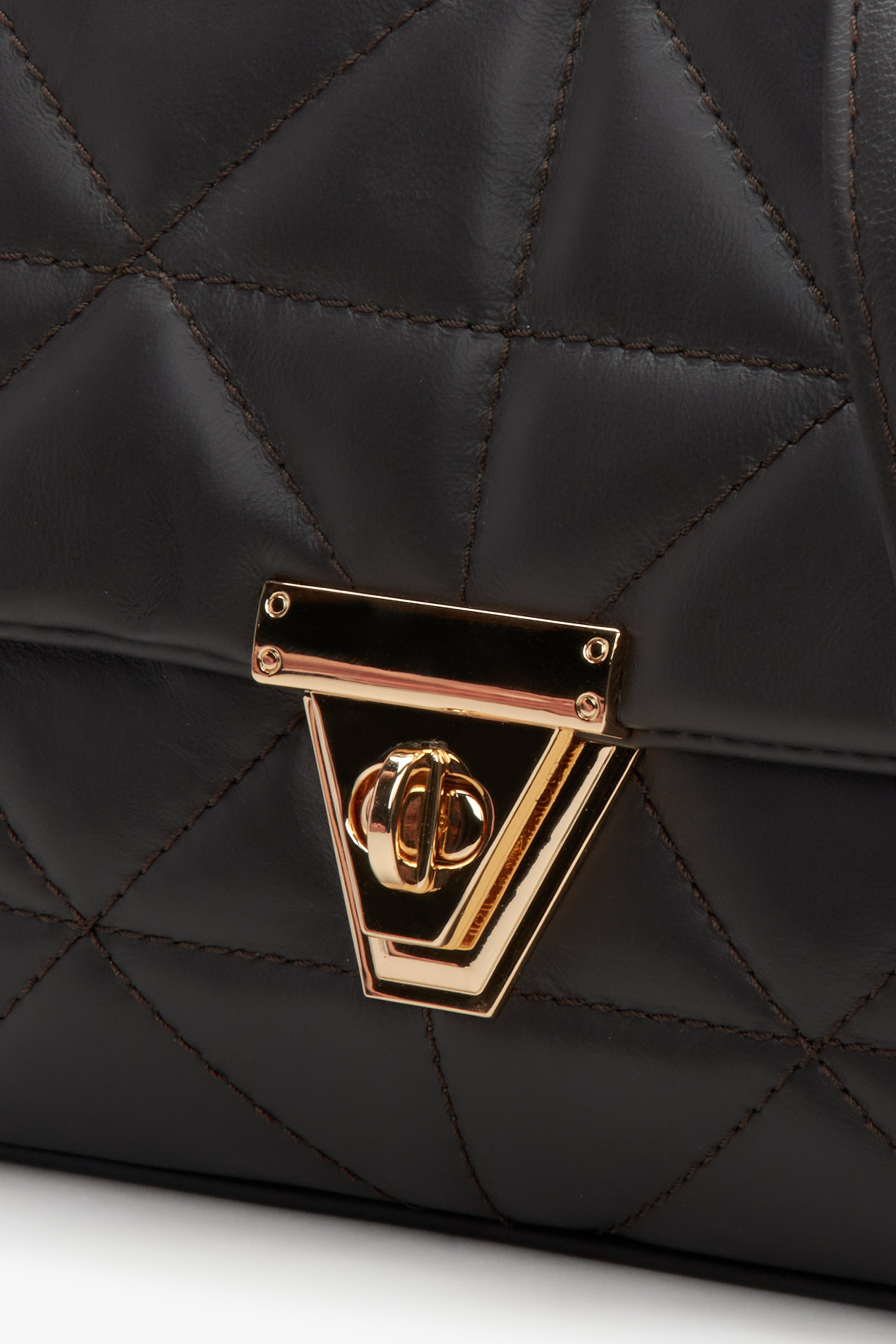 Dark brown quilted Estro women's handbag with gold accents - close-up on the detail.