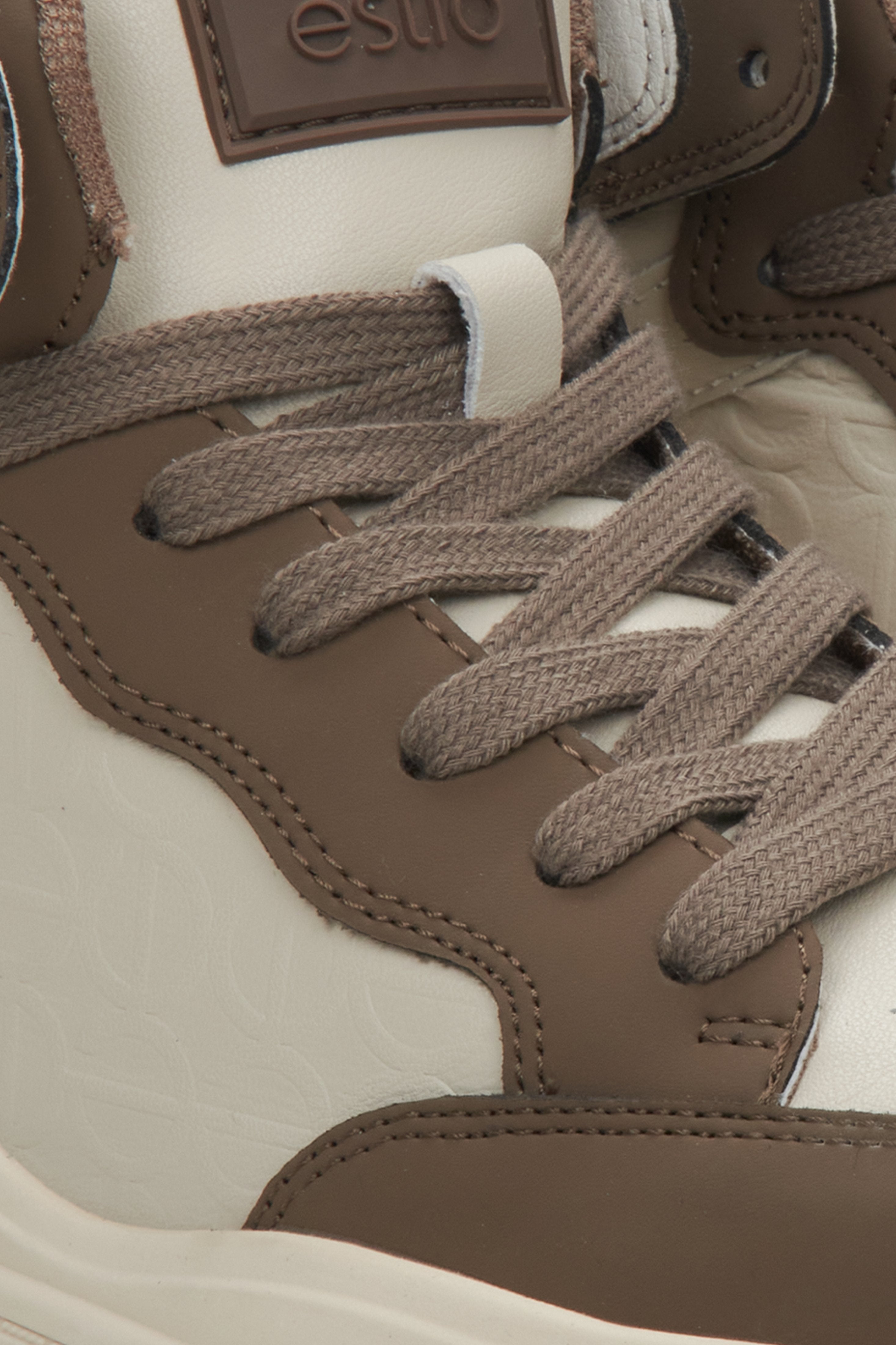 High-top women's sneakers made of genuine leather in beige-brown by Estro - close-up on details.