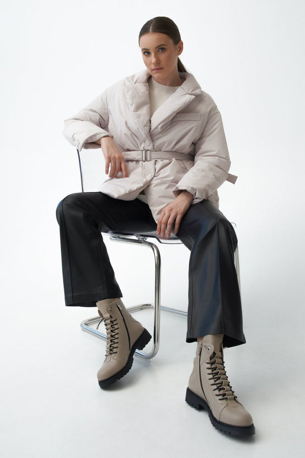 Women's beige boots for winter made of genuine leather - presentation on a model.