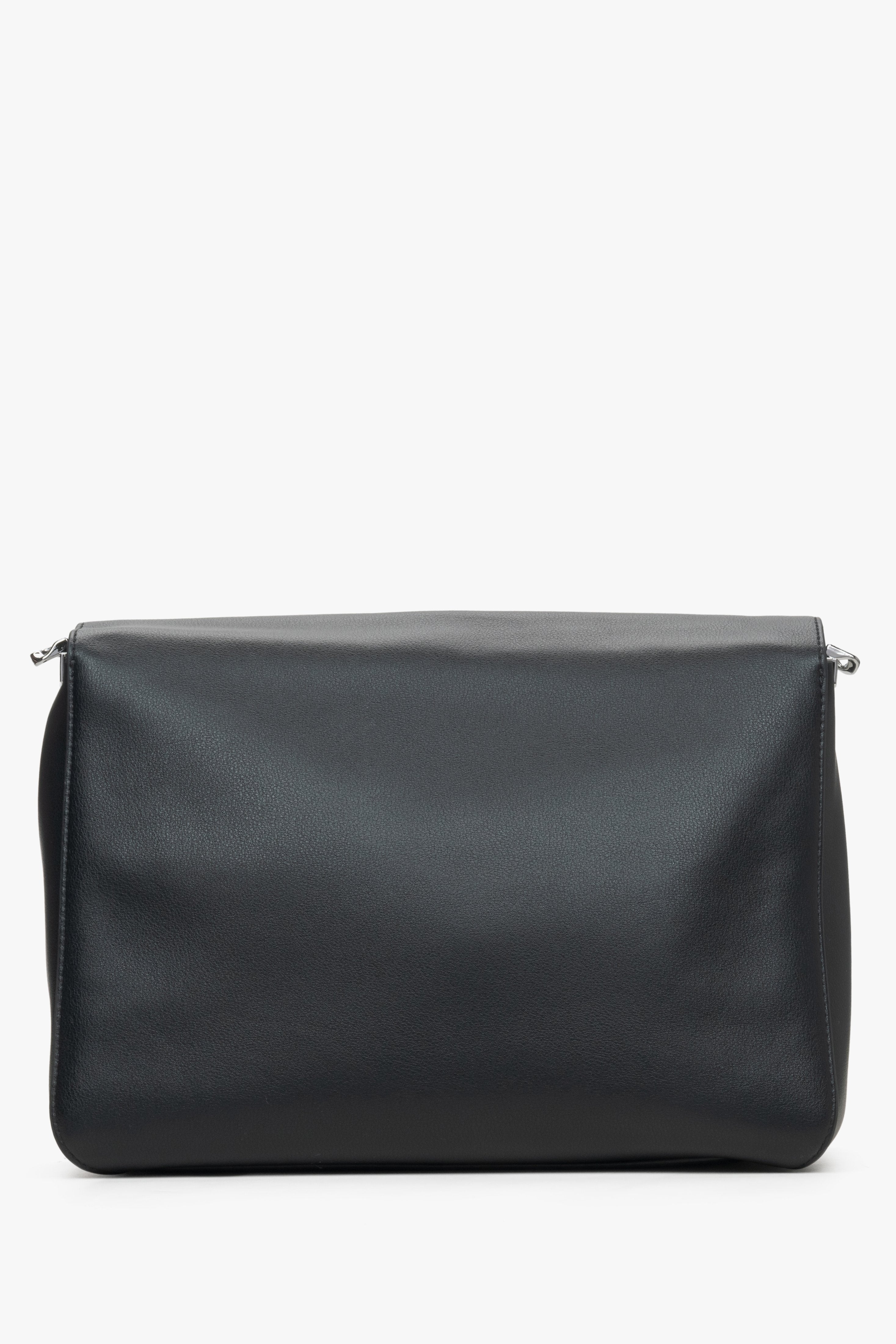 Estro women's black leather crossbody bag with a chain - back view of the model.