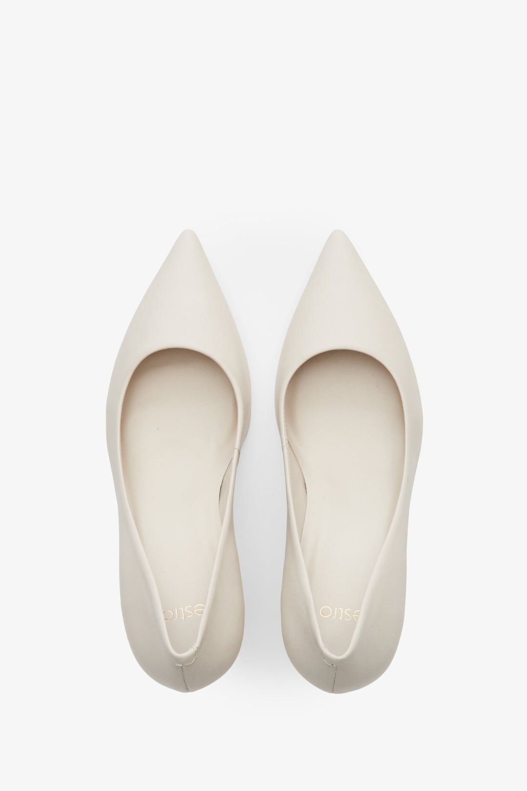 Women's light beige leather pumps by Estro with a low stiletto heel and pointed toe - top view presentation of the model.