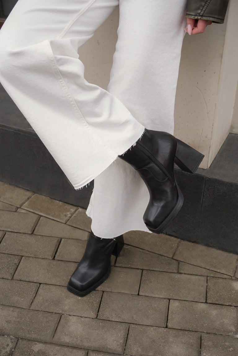 Women's black leather ankle boots - presentation on a model.