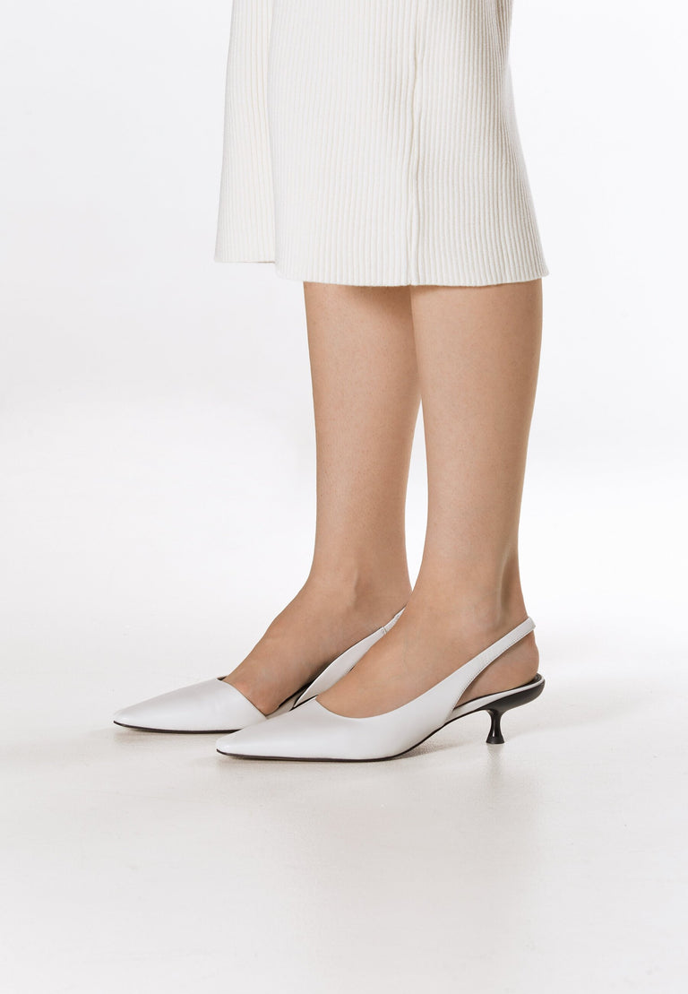 White slingback pumps with a low heel, made of genuine leather by Estro - on-foot presentation.