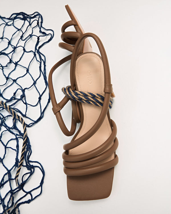 Women’s brown heeled sandals by Estro with a wide, square toe.