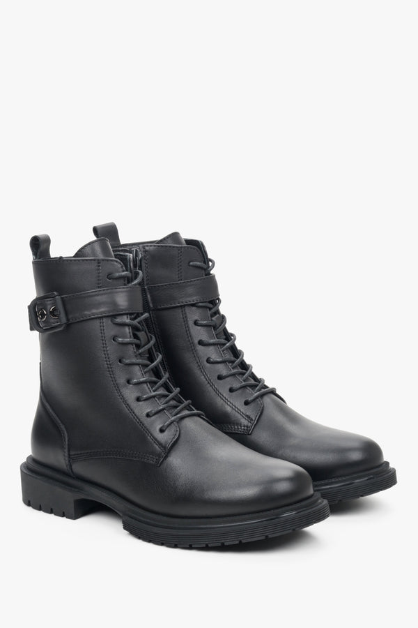 Women's black winter boots with insulation made of genuine leather - close-up on the front and side seam of the shoe.