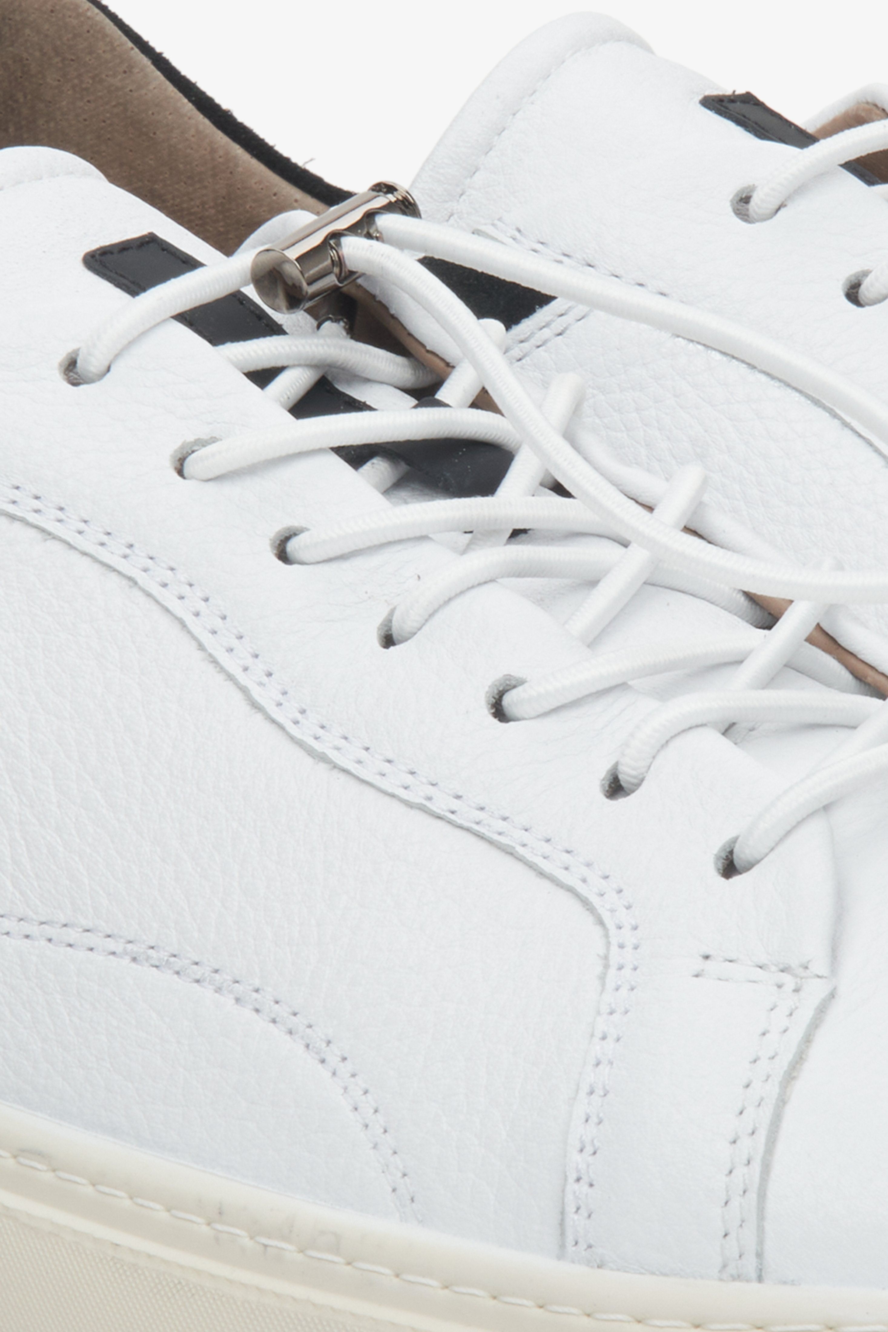 Men's white leather Estro sneakers for spring - close-up of the lacing system and stitching.