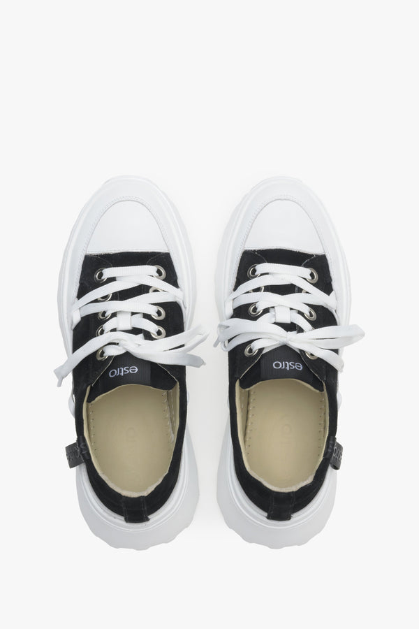 Women's white and black sneakers with perforated sole - top view presentation of the model.