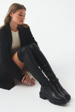 High black leather women's boots for autumn by Estro - presentation on a model.