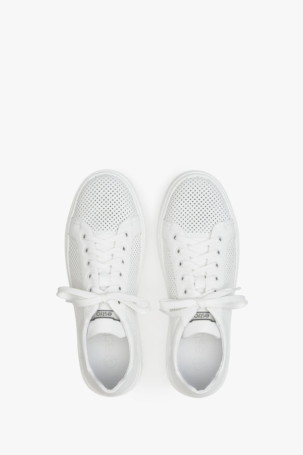 Men's white leather summer sneakers with perforation - presentation of the footwear from the top.