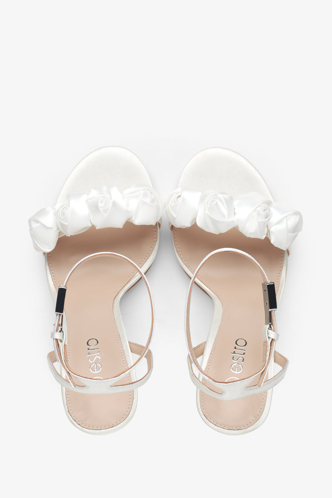 Women's white sandals with floral ornamented heels - top view presentation.