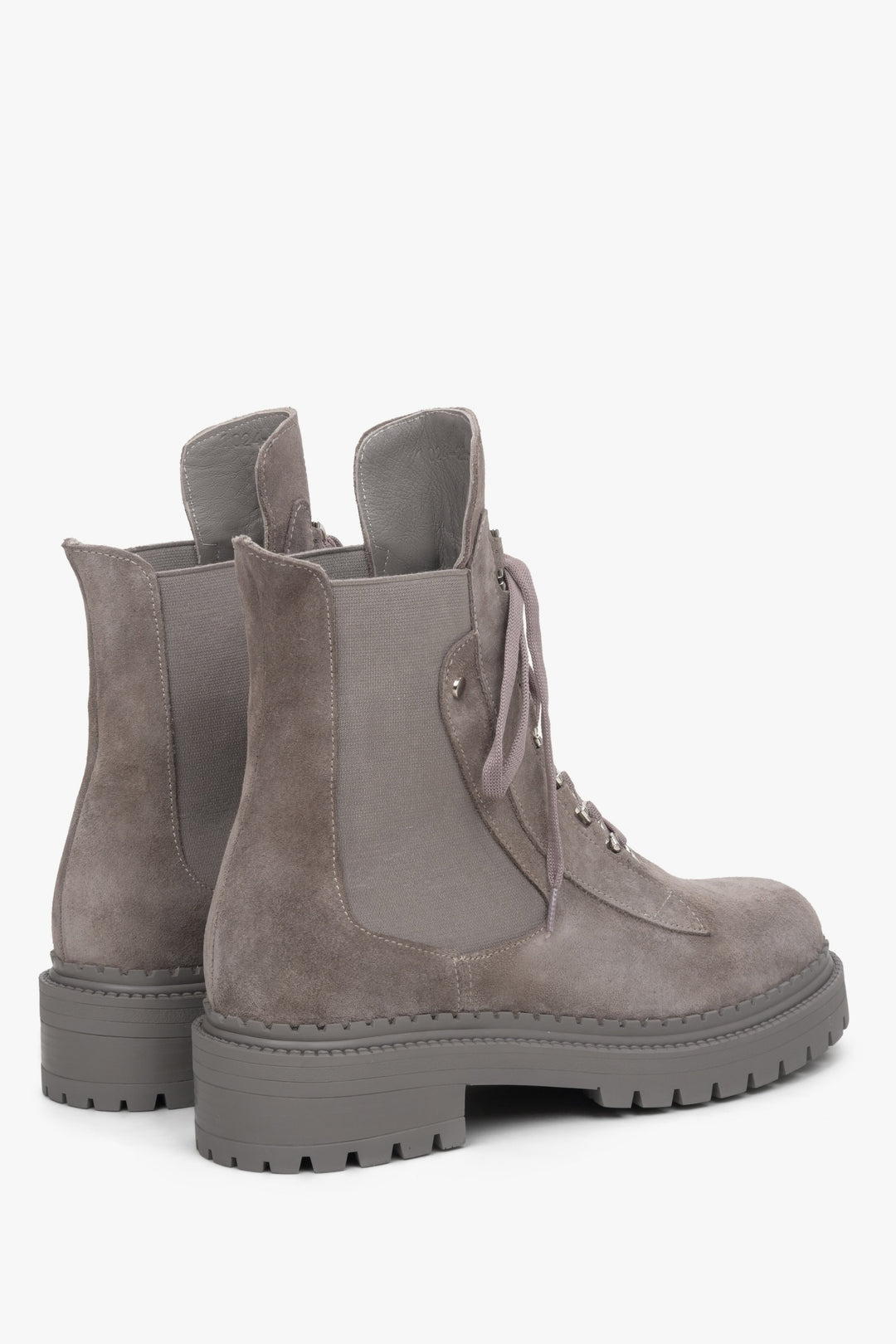 Women's grey velour ankle boots in black - close-up on shoeline.