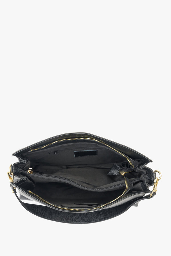 Large black Estro women's handbag with gold accents - close-up of the interior of the model.