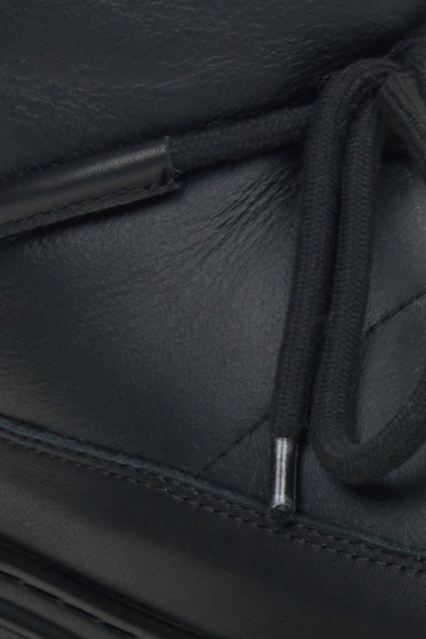 Black leather snow boots by Estro - a close-up on details.
