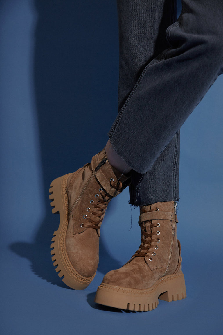 Women's low brown ankle boots made of genuine velour with a decorative strap.