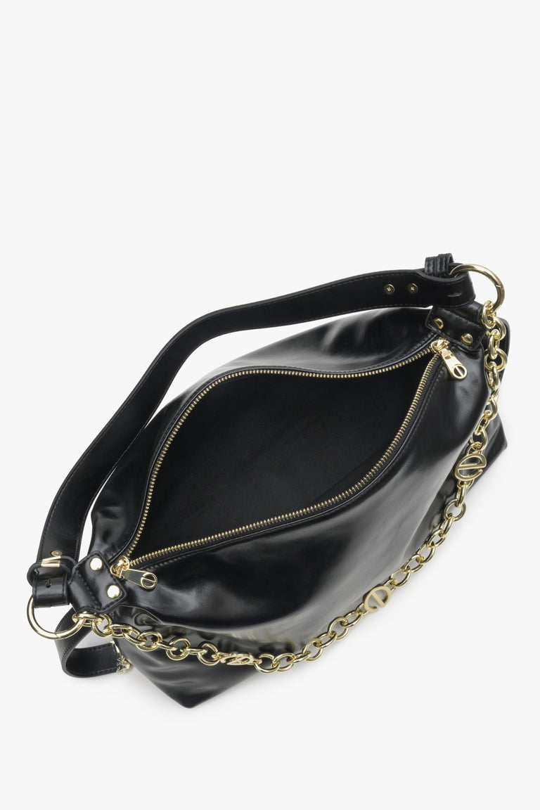 Spacious women's black handbag with chain - close-up of the interior of the model.