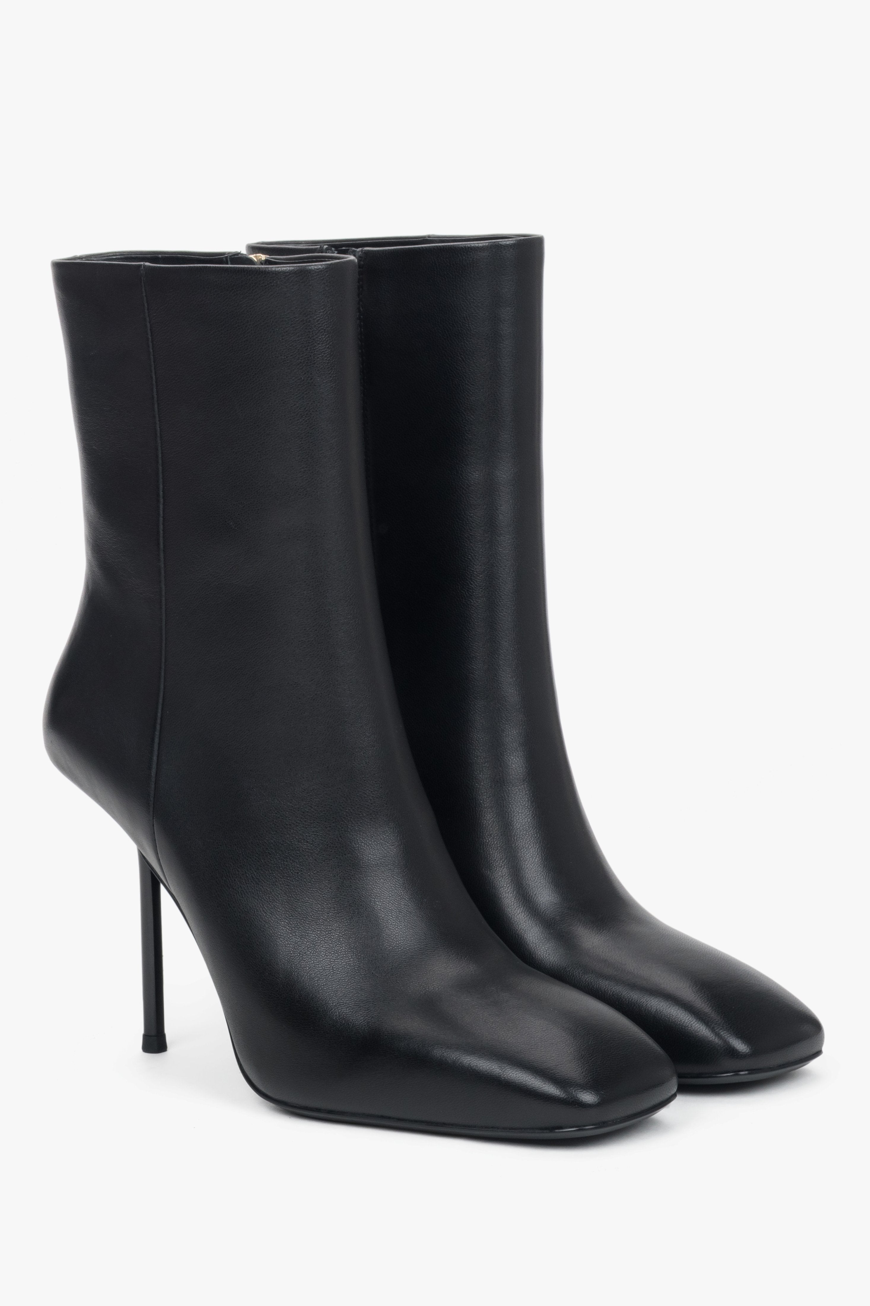 A pair of women's black leather ankle boots featuring a sharp stiletto heel.