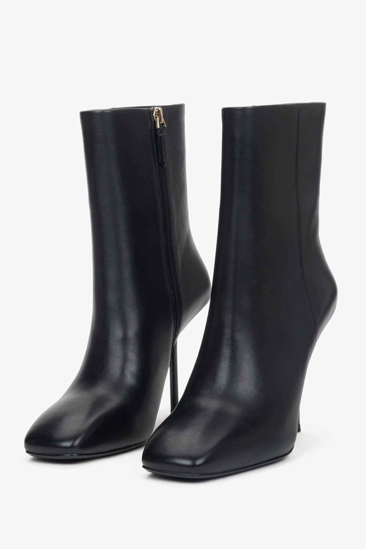 Genuine leather crafted into a pair of women's black ankle boots with a high stiletto heel.