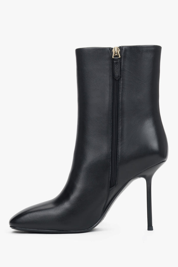 A pair of women's classic black ankle boots designed with a sleek genuine leather upper and a stiletto heel.