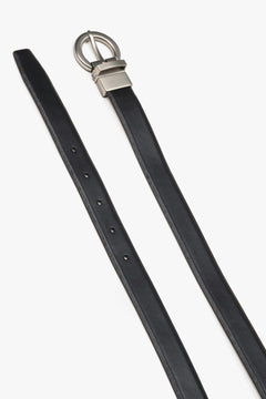 Women's black leather belt by Estro featuring a circular silver buckle.
