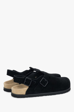 Genuine suede crafted into a pair of women's black closed-toe clog-style sandals.