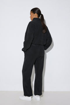 Women's black fleece tracksuit set Estro - back view highlighting the comfortable cut and hooded detail.
