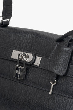 Black women’s shoulder bag from Estro, adorned with silver-tone hardware for understated elegance- details.