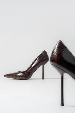 Women's brown high heels with a faux snakeskin pattern.