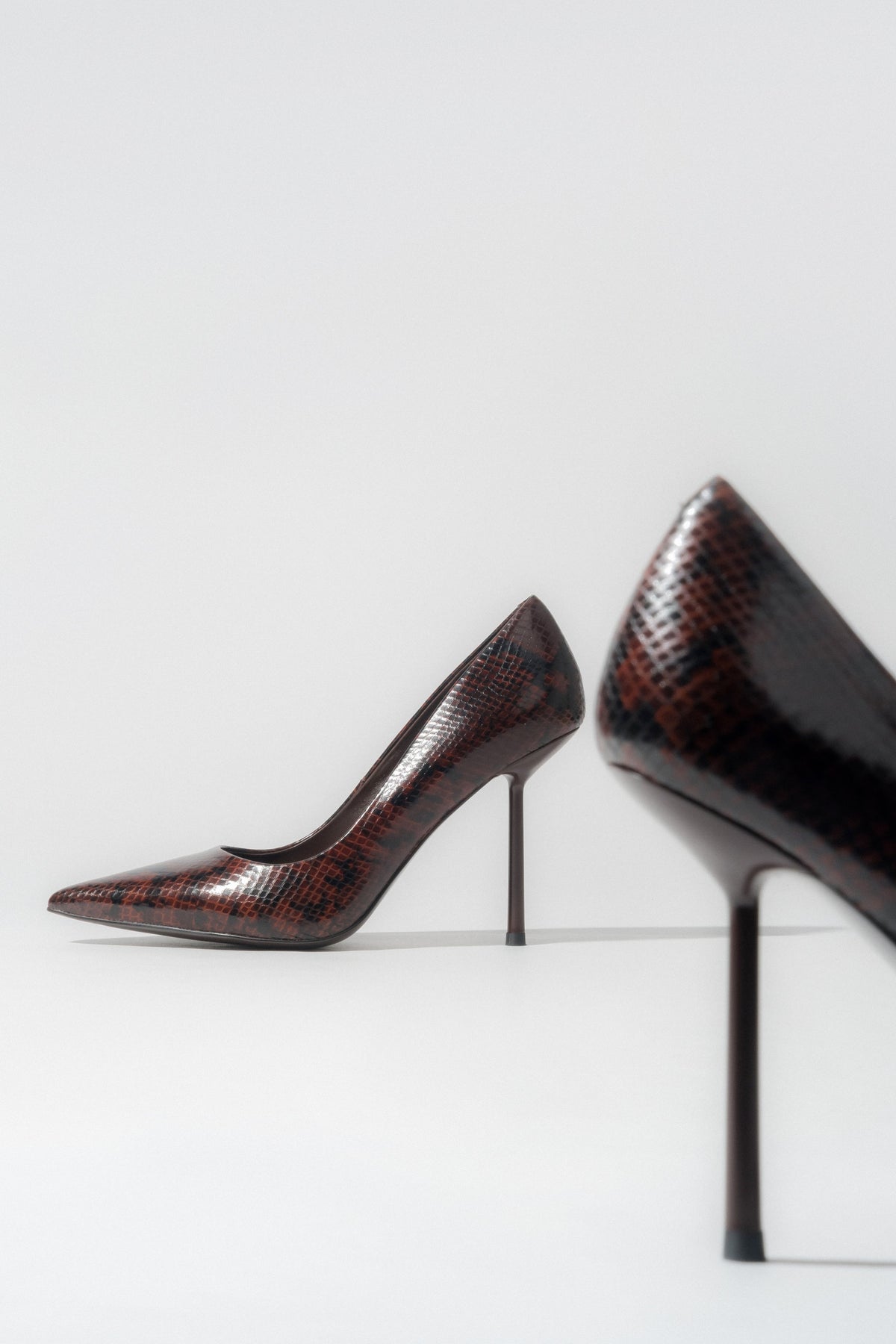 Women's brown high heels with a faux snakeskin pattern.