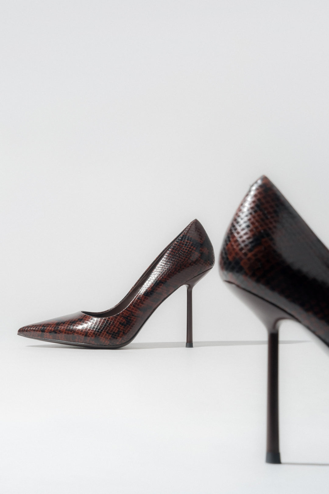 Women's brown high heels with a faux snakeskin pattern.